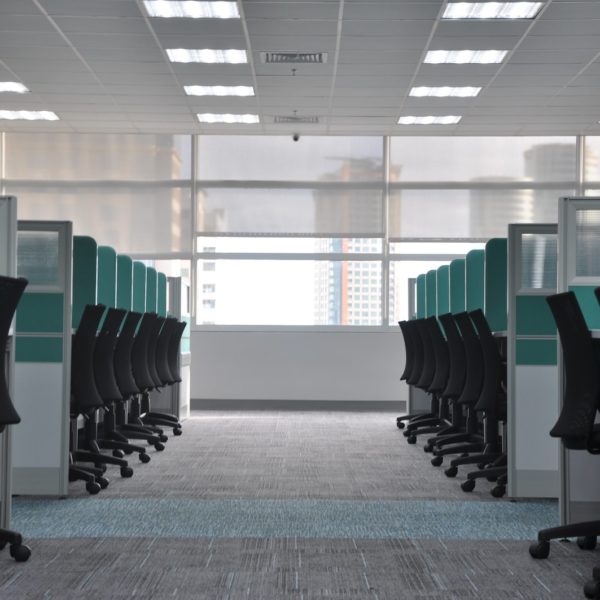 empty black rolling chairs at cubicles